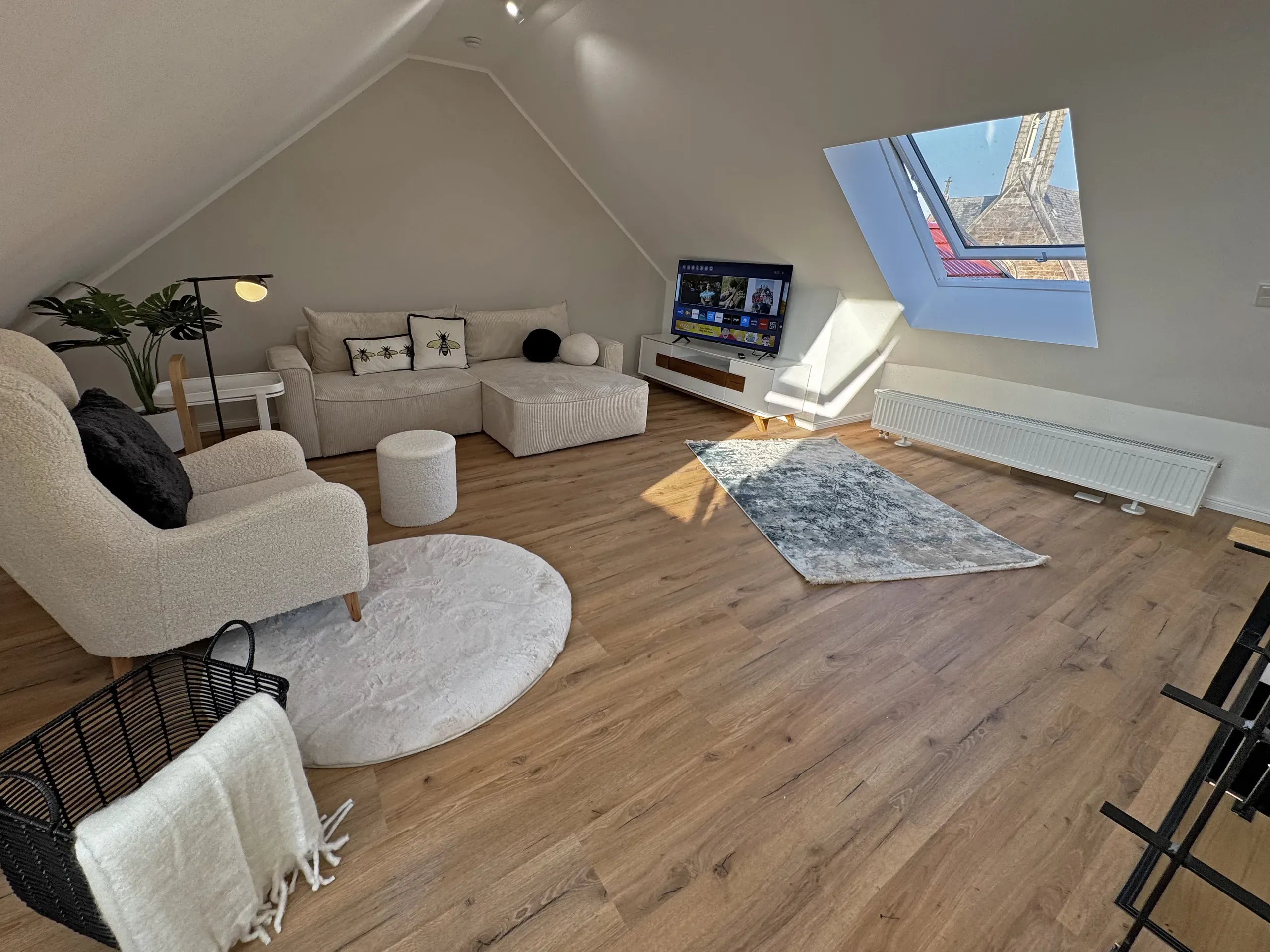 Wohnbereich der Maisonette Klara im VIOS Townhouse mit weißem Sofa, Wohnen auf Zeit in Bad Oeynhausen.